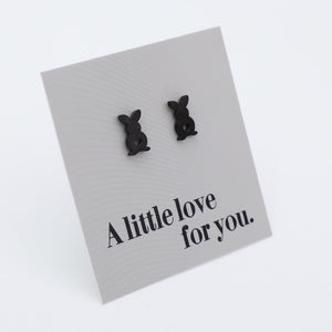 Black bunny-shaped earrings on a card with 'A little love for you.' text