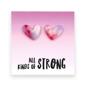 Heart-shaped earrings on a card with 'all kinds of strong' text