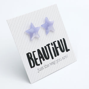 Two lavender star-shaped stud earrings displayed on a white textured card with the word 'BEAUTIFUL' and the phrase 'just the way you are!' on a clean white background.