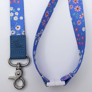 Floral patterned lanyard with metal clip on a white background
