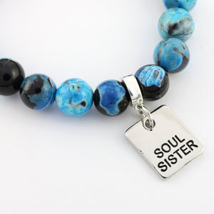 Beaded bracelet with 'Soul Sister' charm on a white background