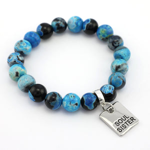 Blue and black beaded bracelet with a 'Soul Sister' charm on a white background