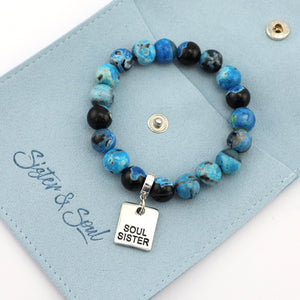 Beaded bracelet with 'Soul Sister' charm on a blue card, featuring the brand 'Sister & Soul'.