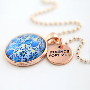 Necklace with floral pendant and 'Friends Forever' tag on a white background