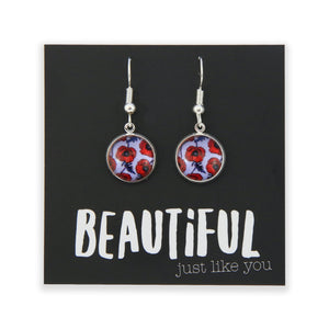 Pair of earrings with floral design on a card with motivational text