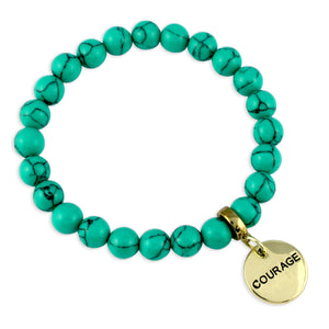 Turquoise beaded bracelet with a gold 'COURAGE' charm on a white background