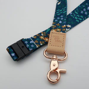 You Got This embossed on a dark blue floral lanyard with tan trim and a lobster clasp.