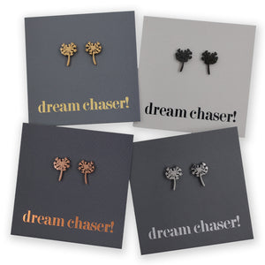 Four pairs of dandelion-themed earrings on cards with 'dream chaser!' text.