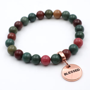 Beaded bracelet with a 'Blessed' charm on a white background