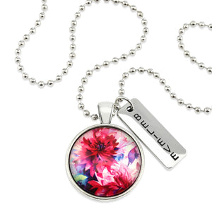 Pink floral print silver circle pendant necklace with 'believe' charm. A product that fundraises for the National Breast Cancer Foundation.