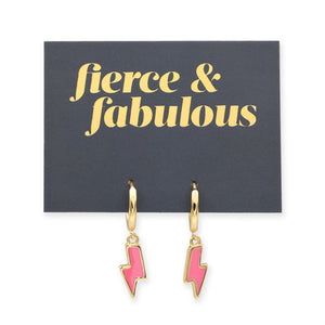 Pink lightning bolt shaped huggies dangle earrings presented on a grey card with gold 'Fierce & Fabulous' writing.