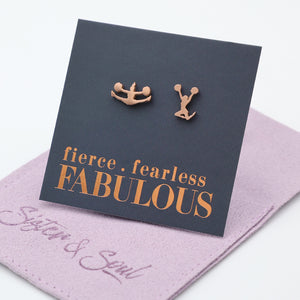 Cheer leader shaped Rose gold earrings on a card with 'fierce fearless FABULOUS' text, placed on a pink surface.