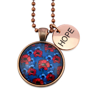 Necklace with floral pendant and 'HOPE' tag on a white background