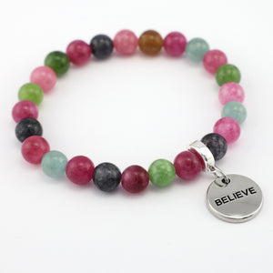 Multicolored beaded bracelet with a silver 'BELIEVE' charm on a white background