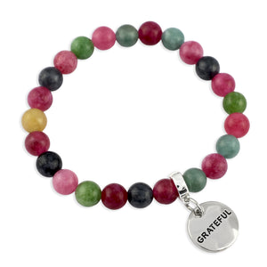 Multicolored beaded bracelet with a 'GRATEFUL' charm on a white background