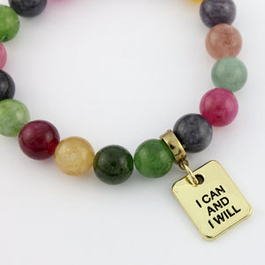 Colorful beaded necklace with a gold 'I Can And I Will' charm on a white background