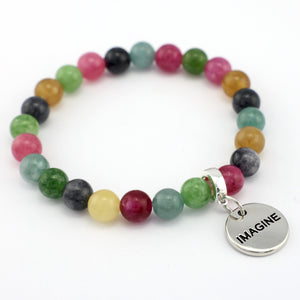 Multicolored beaded bracelet with a silver 'IMAGINE' charm on a white background