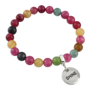 Multicolored beaded bracelet with a 'SHINE' charm on a white background