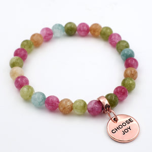 Multicolored beaded bracelet with a 'CHOOSE JOY' charm on a white background