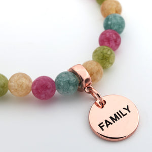 Necklace with multicolored beads and a rose gold 'FAMILY' charm on a white background