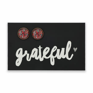 Earring card with 'grateful' text and two round earrings on a black background