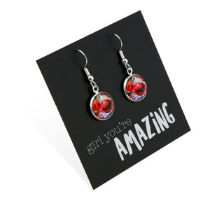 Dangle earrings with floral design on a black card with 'girl you're amazing' text