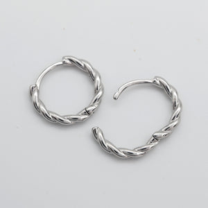 Open silver twisty hoops on a grey card that has silver writing saying "Hello Gorgeous" on a white background