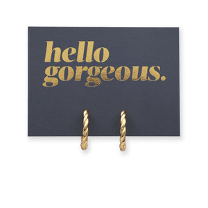 Gold twisty hoops grey card with gold writing "Hello Gorgeous" on a white background