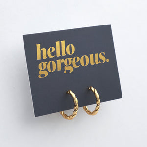 Gold twisty hoops grey card with gold writing "Hello Gorgeous" on a white background