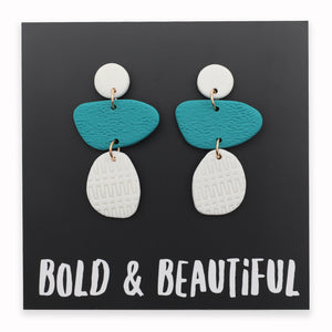 Pair of earrings with blue and white teardrop shapes on a black background with 'Bold & Beautiful' text.
