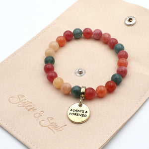 Multicolored beaded bracelet with a 'Always & Forever' charm on a branded card.