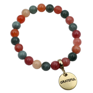 Multicolored beaded bracelet with a gold 'GRATEFUL' charm on a white background