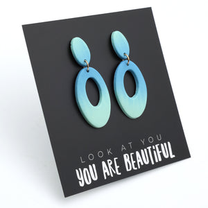 Blue ombre earrings on a black card with 'Look at you, you are beautiful' text.
