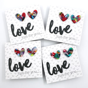 Heart-shaped earrings on a card with 'love just for you...' text