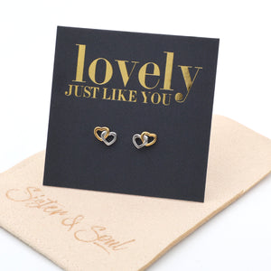 Heart-shaped earrings on a 'lovely JUST LIKE YOU' card with a beige pouch underneath.