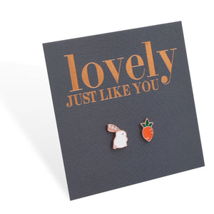 A pair of Easter style sterling silver stud earrings with one designed as a bunny and the other as a carrot, presented on a card with 'lovely just like you' printed in rose gold lettering.