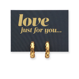 Gold hoop earrings on a love just for you card