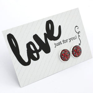 Red and black speckled earrings on a 'Love just for you!' card