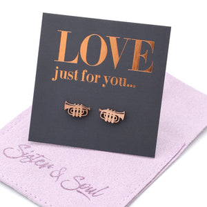 Rose gold trumpet earrings on a 'LOVE just for you' card with a purple cloth background