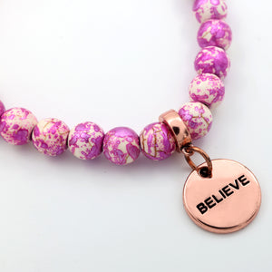 Believe charm on speckled pink bracelet