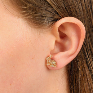 gold glitter shapped bunny studs in girls ear