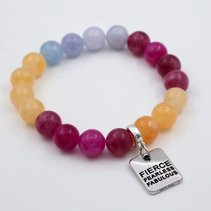 Multicolored beaded bracelet with a silver charm on a white background