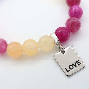 LOVE charm in silver with stone bead bracelet on white background