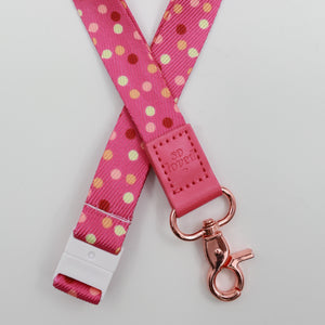 So Loved embossed on a pink polka dot lanyard with pink trim and a lobster clasp.
