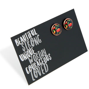Floral patterned earrings on a black card with motivational text