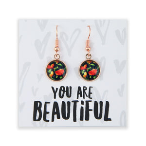 Floral earrings on a card with 'You are Beautiful' text