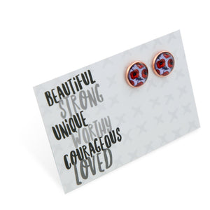 Pair of purple and red poppy earrings on a card with motivational text