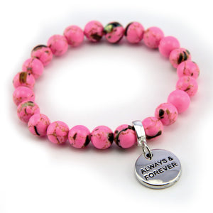 Pink beaded bracelet with a silver 'Always & Forever' charm on a white background