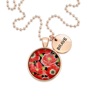 Necklace with floral pendant and 'BRAVE' tag on a white background