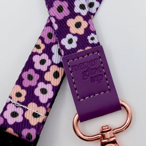 Purple floral-patterned strap with a rose gold clasp on a white background